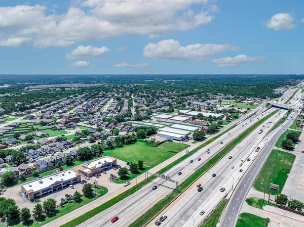 an aerial view of residential house with outdoor space and trees all around