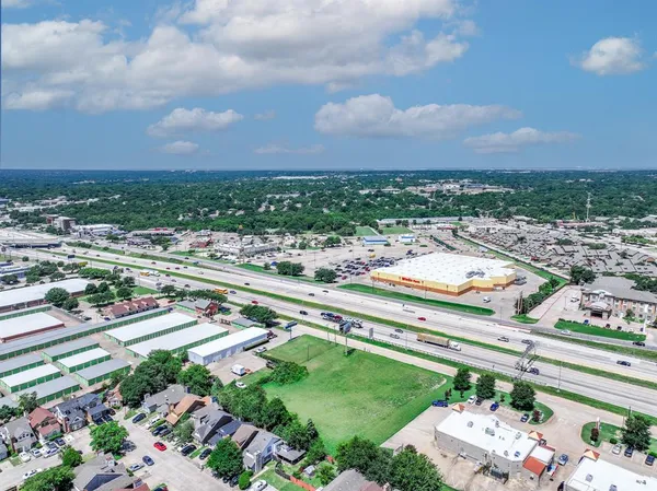 a view of a big house with a big yard and large trees