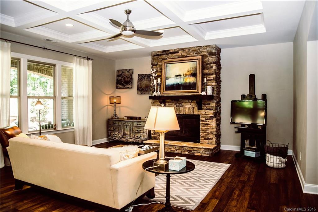 8086 Clems Branch Road Indian Land, SC 29707 - Photo 11 of 23 a living room with furniture a flat screen tv and a floor to ceiling window
