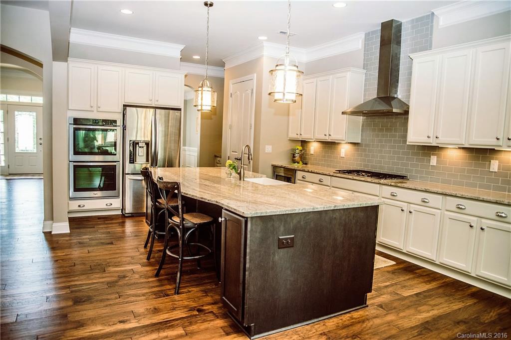 8086 Clems Branch Road Indian Land, SC 29707 - Photo 5 of 23 a kitchen with stainless steel appliances granite countertop a sink stove and refrigerator