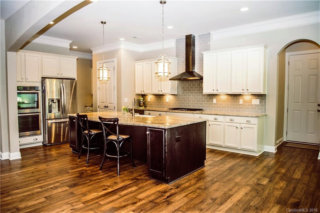 8086 Clems Branch Road Indian Land, SC 29707 - Photo 6 of 23 a kitchen with a sink stove and cabinets