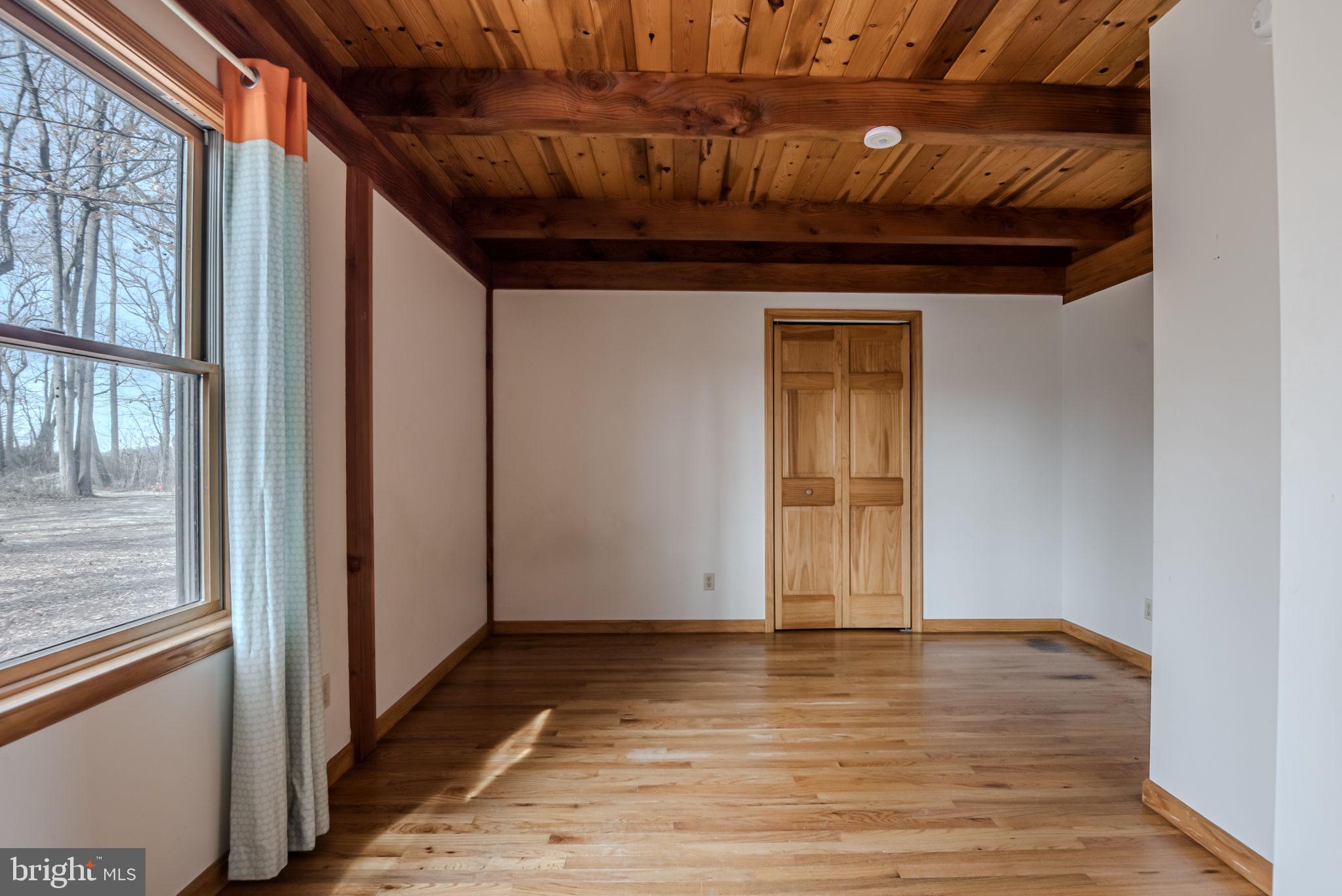 13755 Shallcross Wharf Road Kennedyville, MD 21645 - Photo 20 of 43 a view of a hallway with wooden floor and staircase