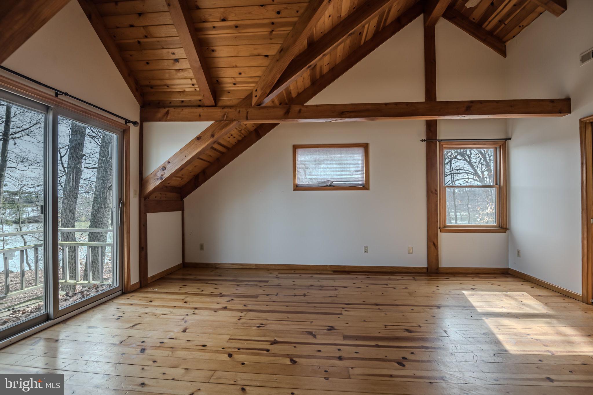 13755 Shallcross Wharf Road Kennedyville, MD 21645 - Photo 23 of 43 a view of an empty room with wooden floor and windows