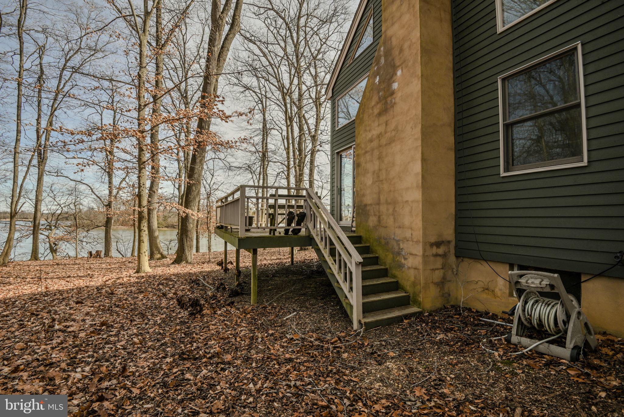 13755 Shallcross Wharf Road Kennedyville, MD 21645 - Photo 37 of 43 a backyard of a house with barbeque oven and bench