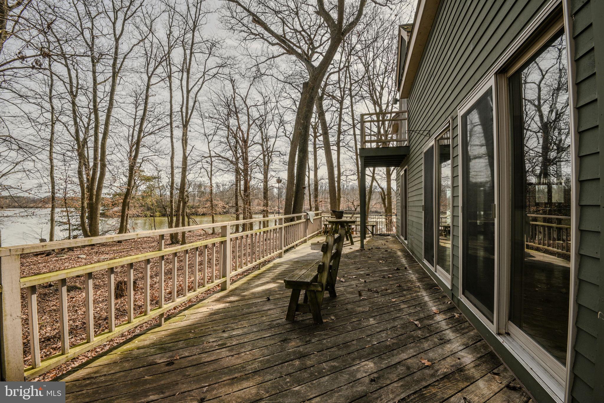 13755 Shallcross Wharf Road Kennedyville, MD 21645 - Photo 39 of 43 a view of a balcony with chairs and wooden fence