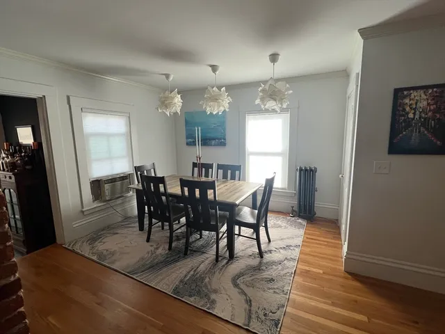 a view of a dining room with furniture and wooden floor