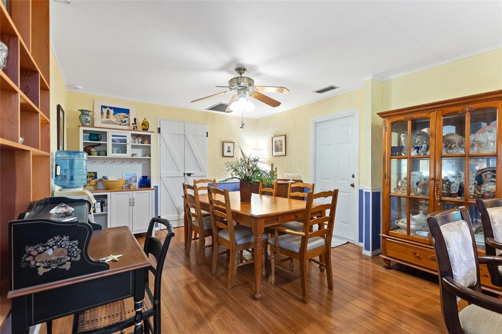 3641 Turtle Mound Road Melbourne, FL 32934 - Photo 11 of 77 a view of a dining room with furniture and wooden floor