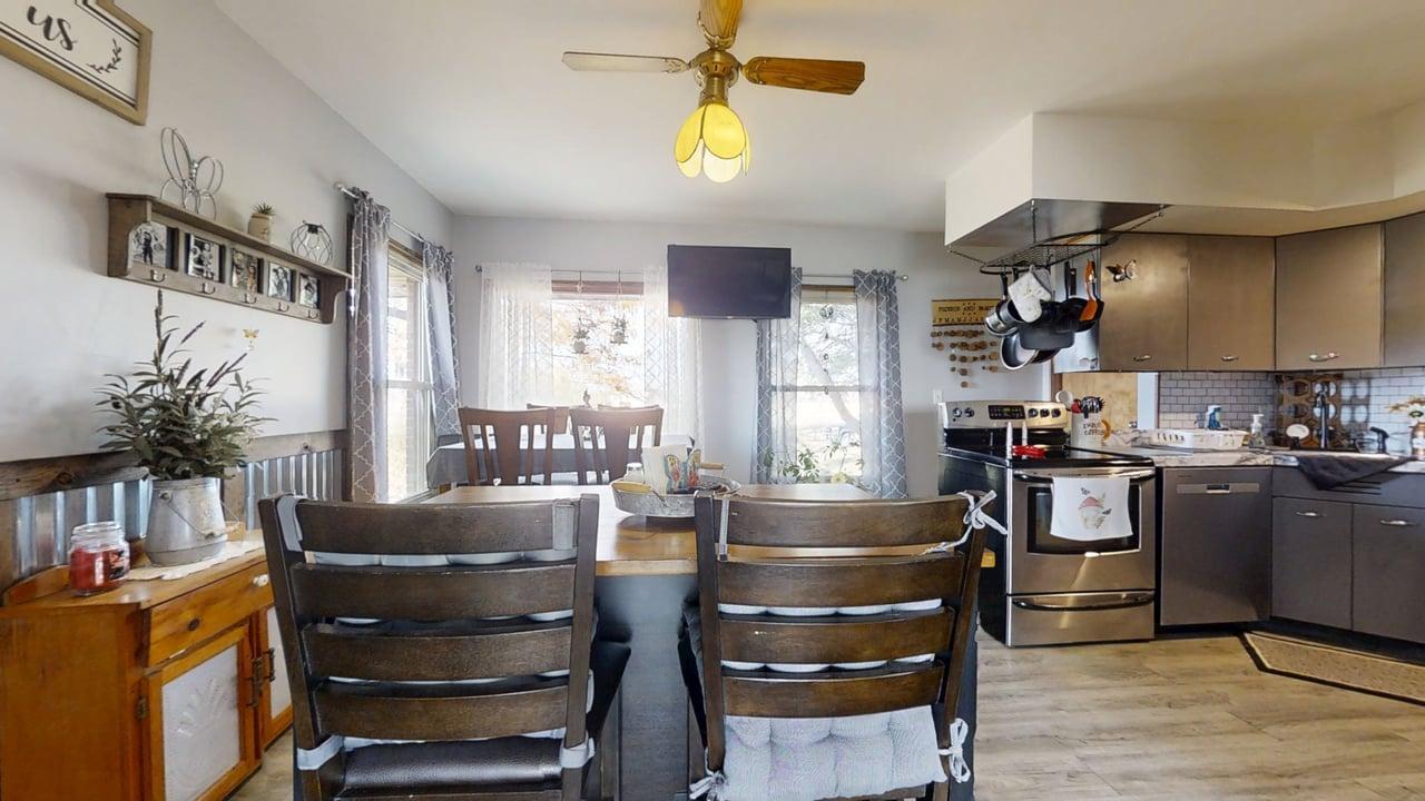 2102 County Road 2900 North Rantoul, IL 61866 - Photo 7 of 34 a kitchen with a refrigerator and a dining table