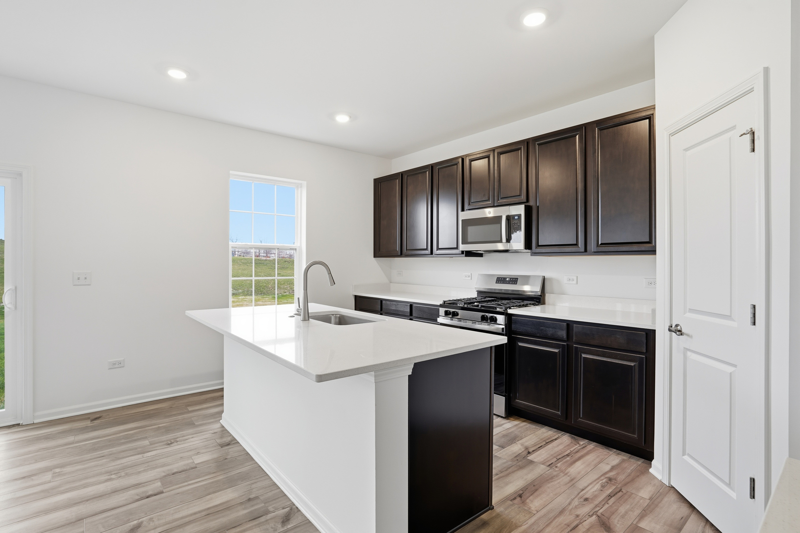 357 Danforth Drive Oswego, IL 60543 - Photo 9 of 22 a kitchen with stainless steel appliances granite countertop a sink stove and refrigerator