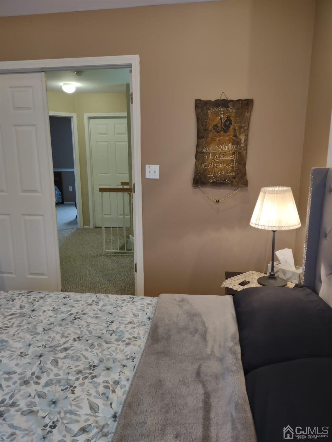 1707 Ridgeview Court Sayreville, NJ 08859 - Photo 23 of 25 a bedroom with a bed and a lamp