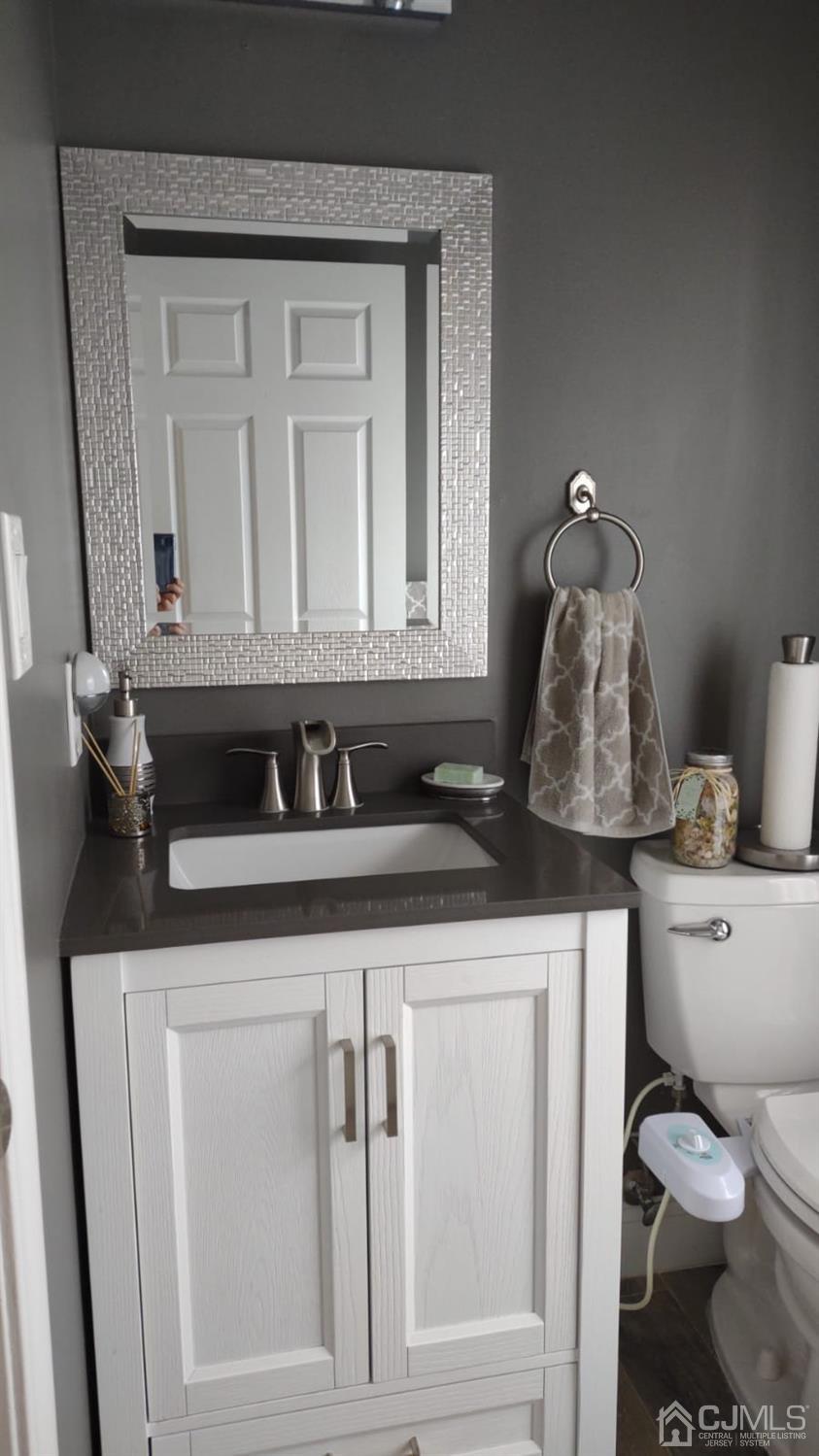 1707 Ridgeview Court Sayreville, NJ 08859 - Photo 4 of 25 a bathroom with a toilet sink and mirror