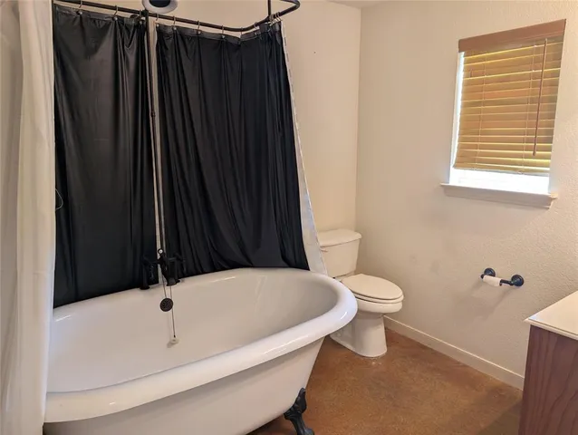a bathroom with a sink a toilet a tub and shower