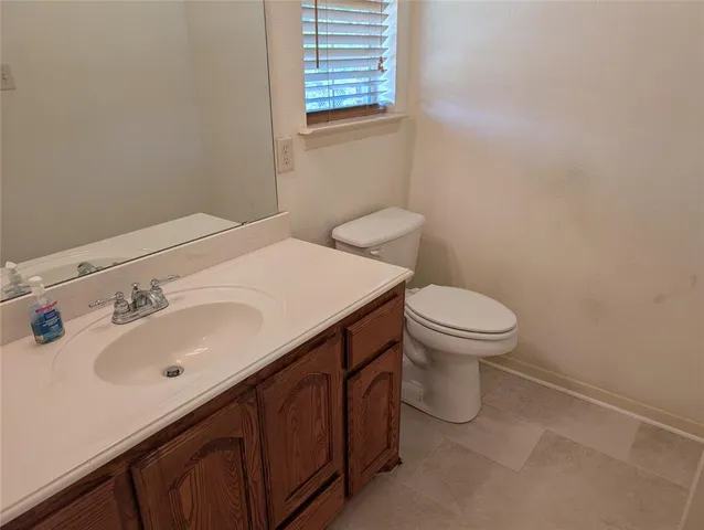 a bathroom with a sink toilet and mirror