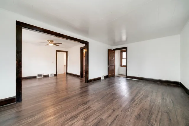 a view of a livingroom with wooden floor and window