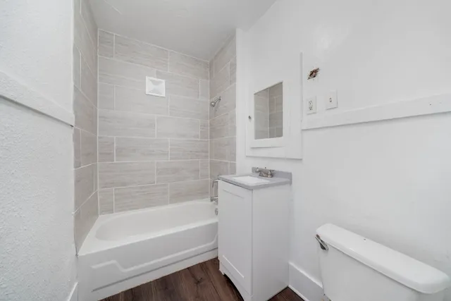 a bathroom with a bathtub and a toilet