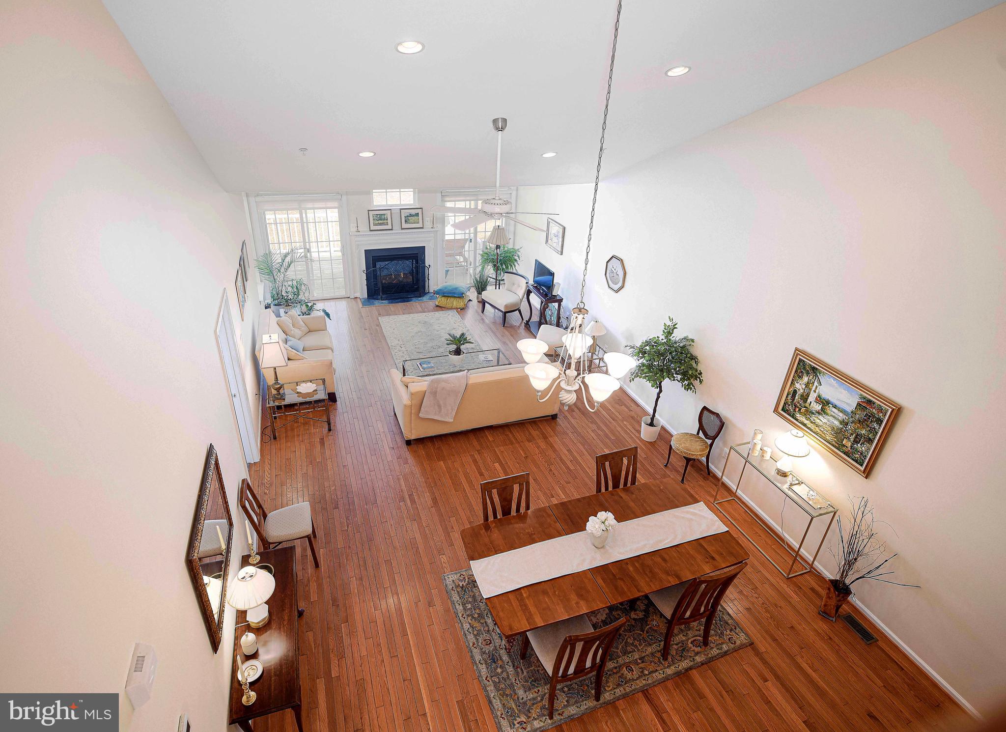 316 Native Dancer Circle Havre de Grace, MD 21078 - Photo 22 of 54 a living room with couches kitchen view and a dining table with wooden floor