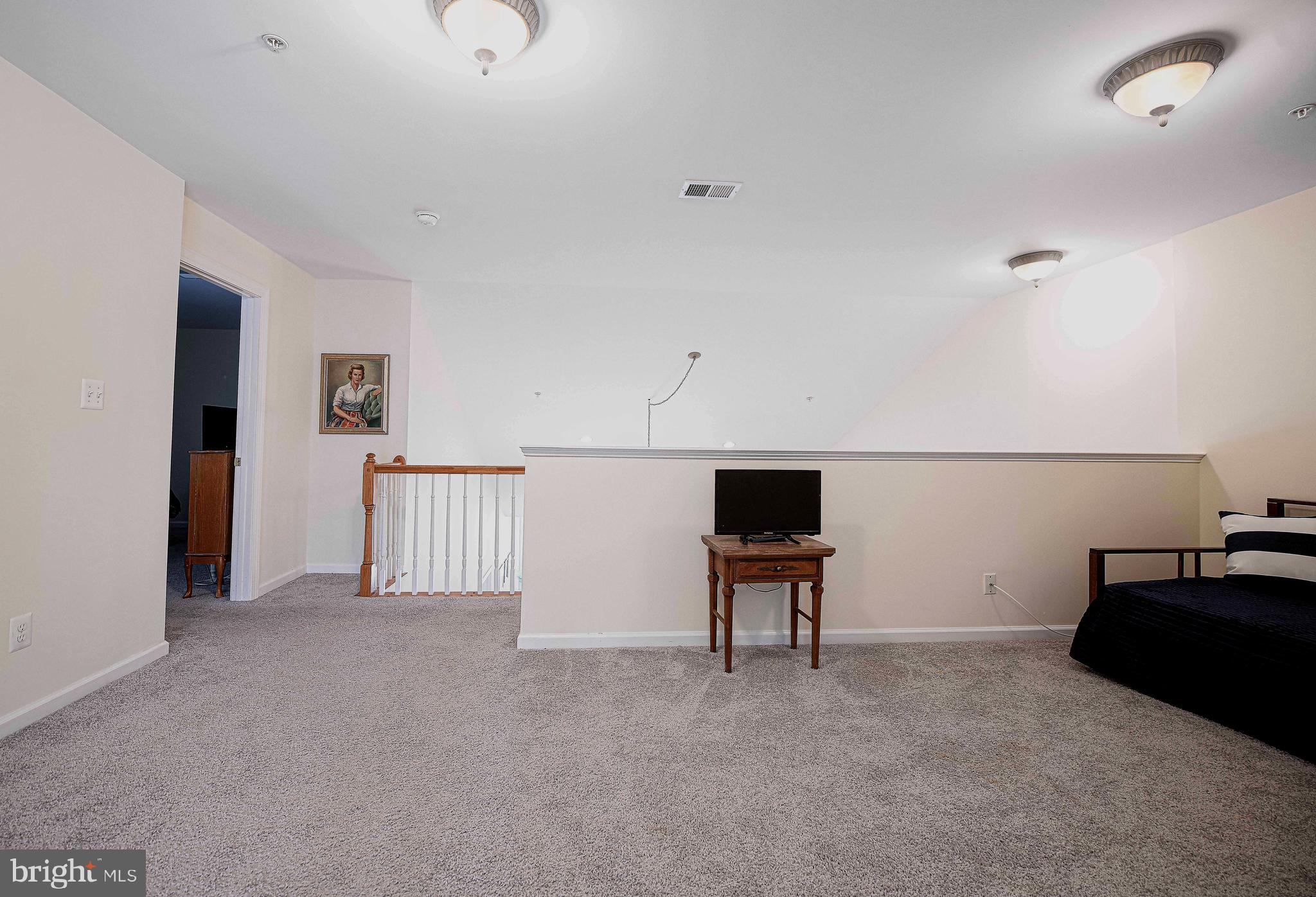 316 Native Dancer Circle Havre de Grace, MD 21078 - Photo 23 of 54 a view of an empty room with wooden floor and windows