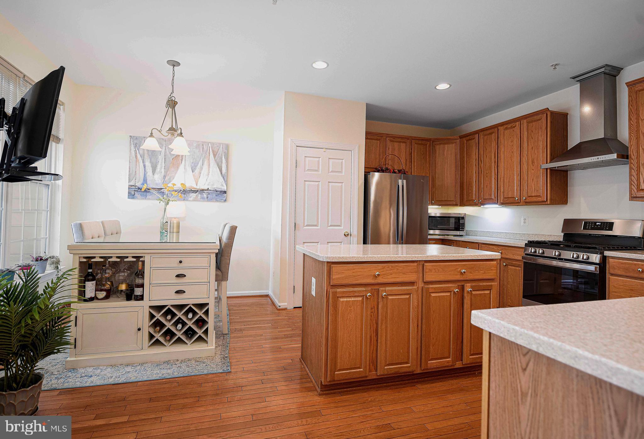 316 Native Dancer Circle Havre de Grace, MD 21078 - Photo 5 of 54 a kitchen with stainless steel appliances granite countertop a stove top oven a refrigerator a sink and dishwasher with wooden floor