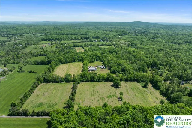 an aerial view of a house with yard