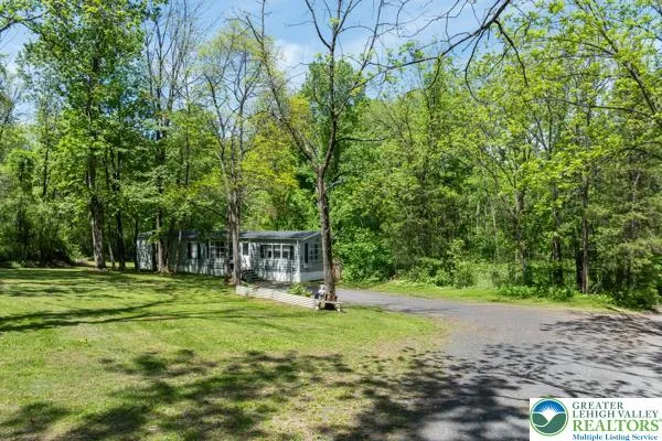 a view of a park with swings and a trees