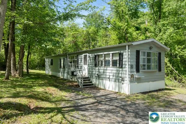 a view of house with backyard outdoor seating and trees