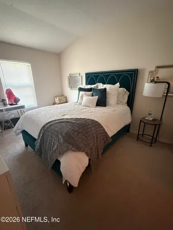 a spacious bedroom with a bed and window