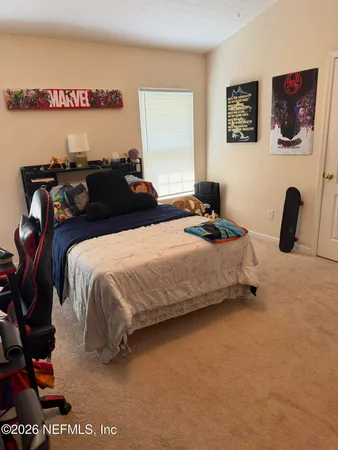 a bedroom with a bed and a desk