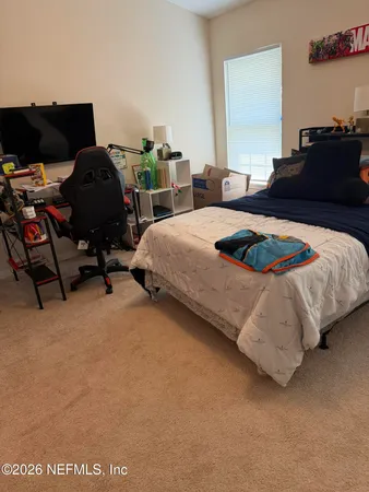 a bedroom with bed and window