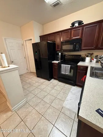 a kitchen with stainless steel appliances a refrigerator and a stove