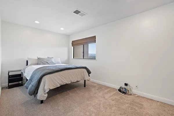 a bed room with a bed and a window