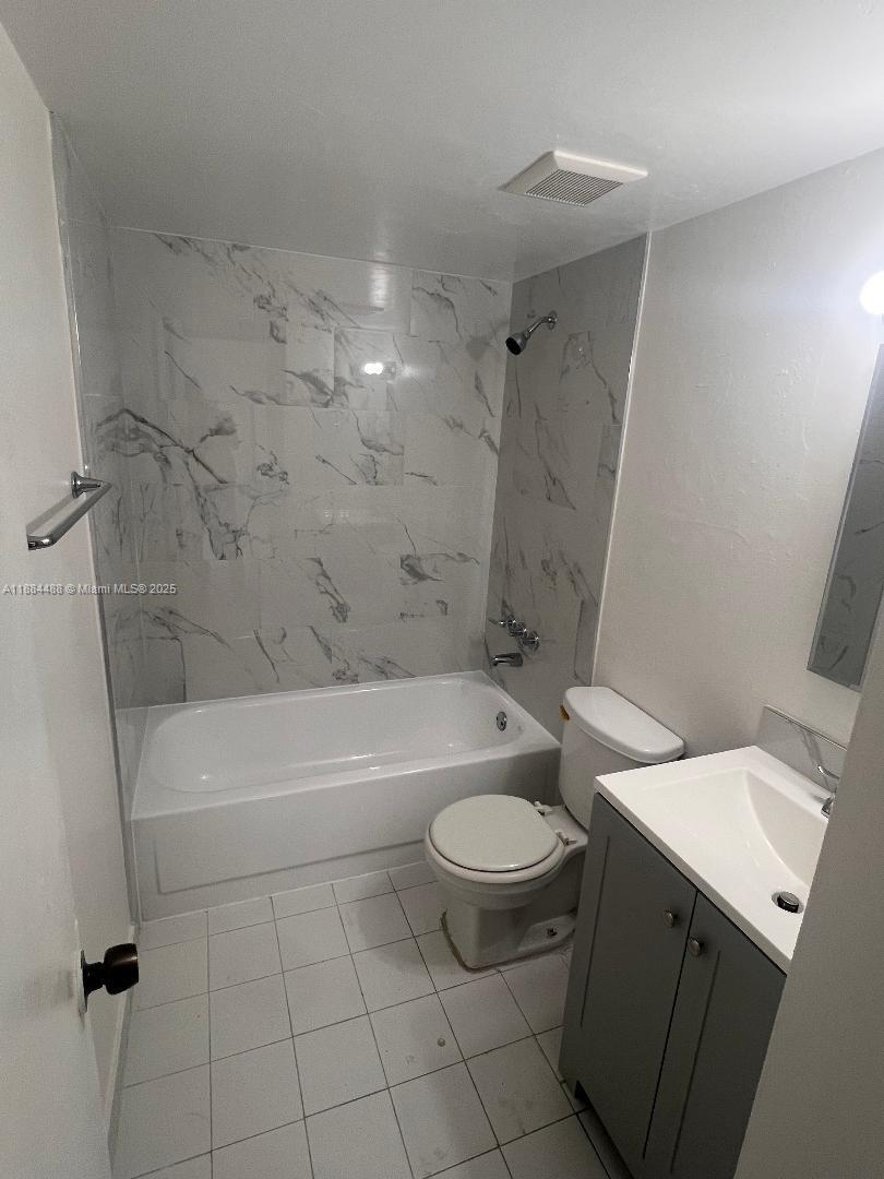 10851 Southwest 2nd Street, Unit K304 Sweetwater, FL 33174 - Photo 12 of 16 a bathroom with a sink a toilet and bathtub