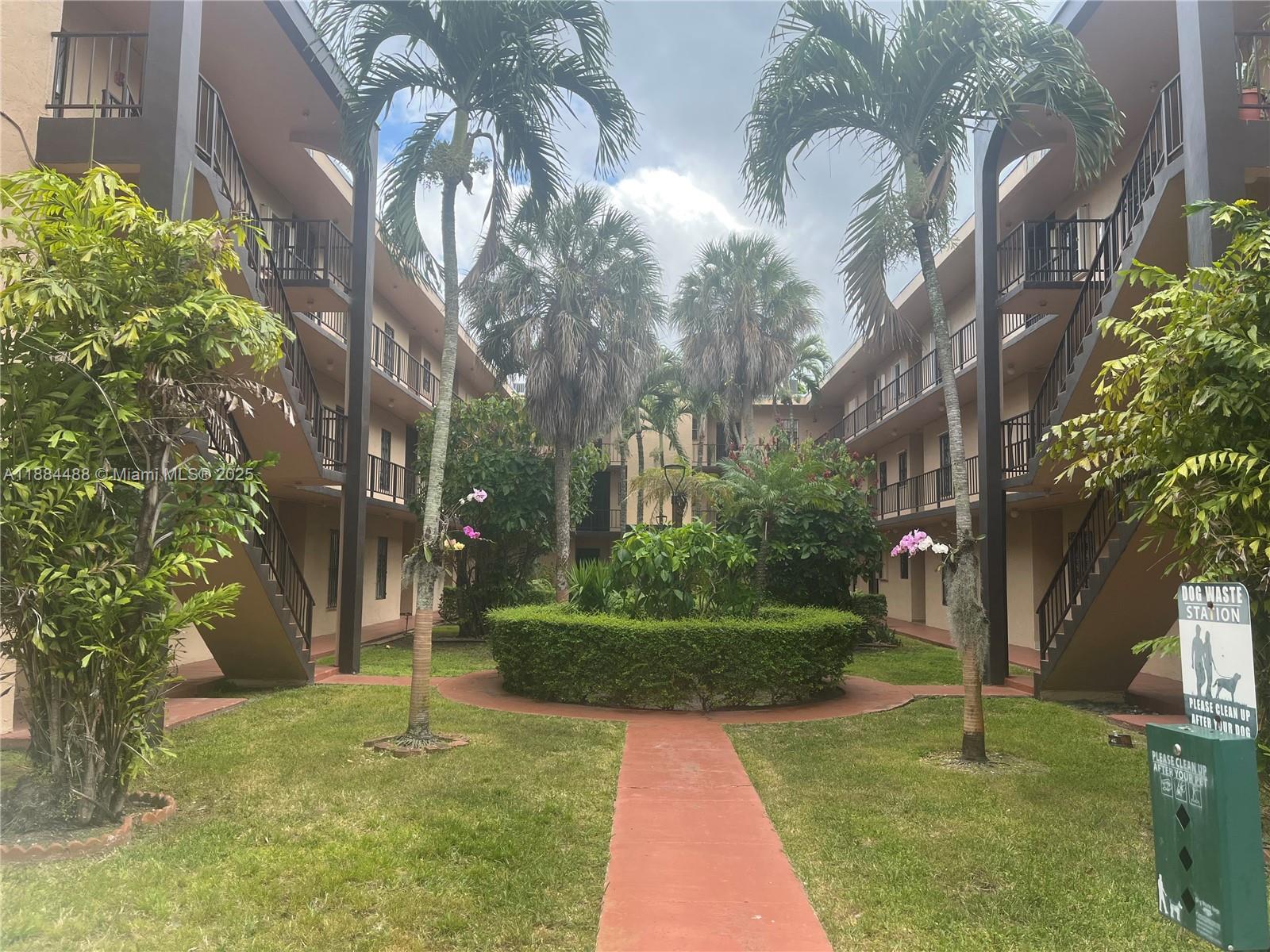 10851 Southwest 2nd Street, Unit K304 Sweetwater, FL 33174 - Photo 14 of 16 a backyard of a house with lots of green space