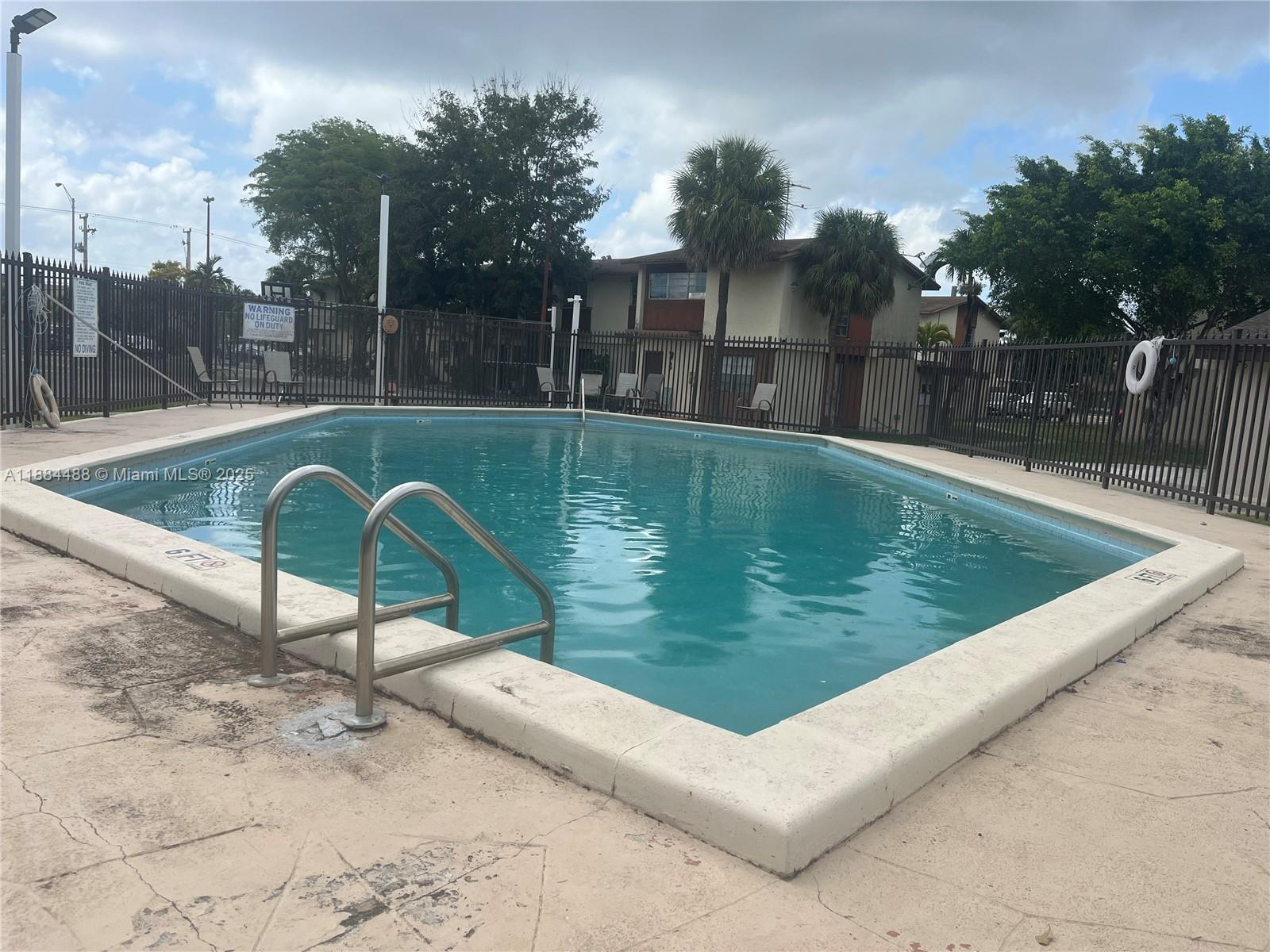 10851 Southwest 2nd Street, Unit K304 Sweetwater, FL 33174 - Photo 16 of 16 a view of a swimming pool with a patio