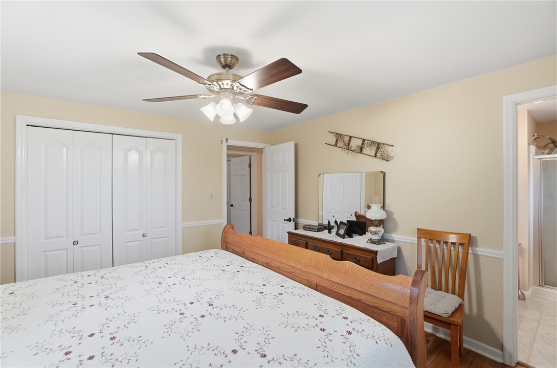 4170 Johnson Road Springfield, OH 45502 - Photo 37 of 54 Wood flooring and a classic ceiling fan provide comfort in this well-appointed bedroom.