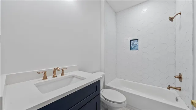 a bathroom with a sink a toilet and bathtub