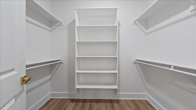a view of walk in closet with empty racks