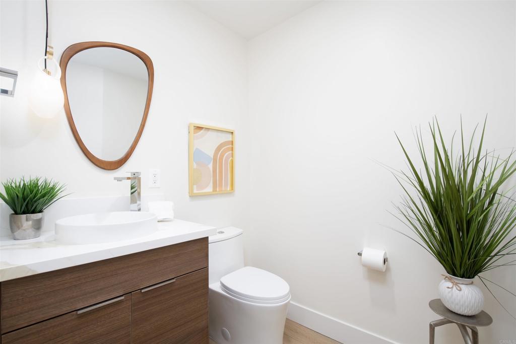 2501 State Street Carlsbad, CA 92008 - Photo 19 of 32 a bathroom with a toilet a sink and a mirror