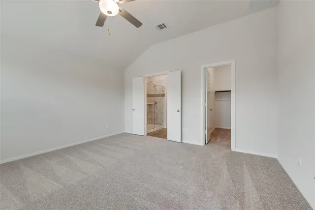 a view of an empty room with a ceiling fan
