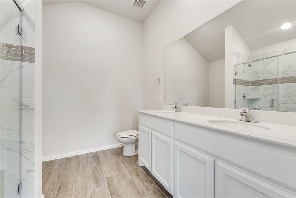 1137 Catalan Trail Mesquite, TX 75149 - Photo 16 of 22 a bathroom with a sink a toilet and a mirror