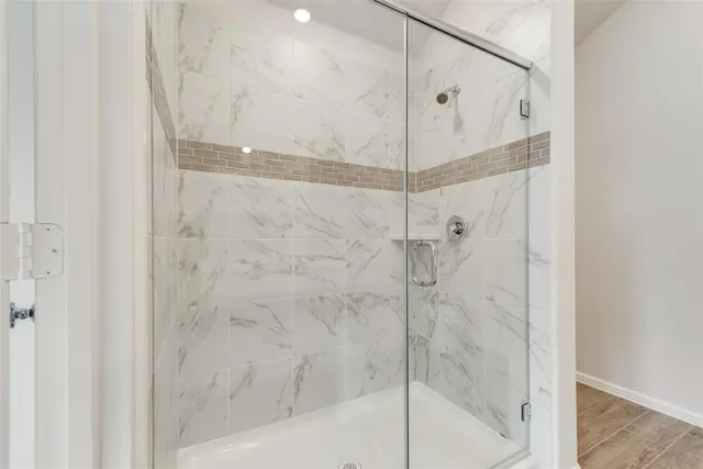 a bathroom with a glass shower door