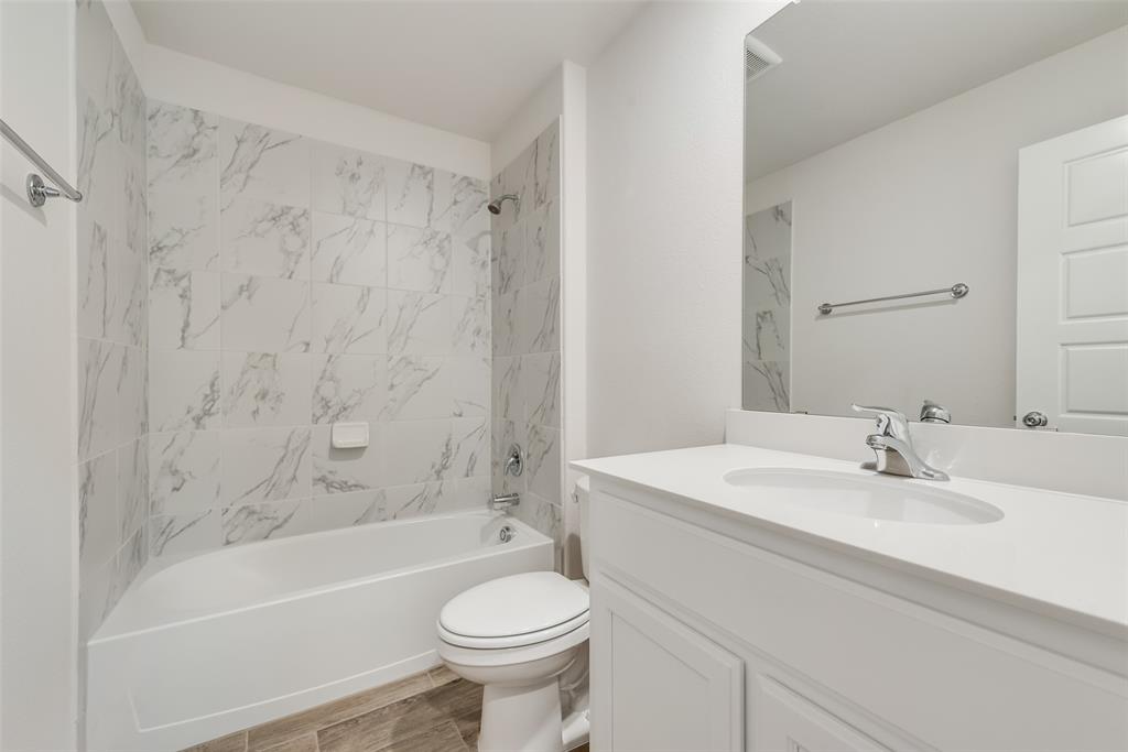 1137 Catalan Trail Mesquite, TX 75149 - Photo 19 of 22 a bathroom with a sink a toilet and a bathtub