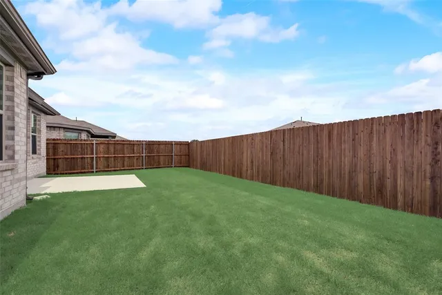 a view of yard with wooden fence