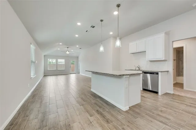 a view of kitchen with sink and wooden floor