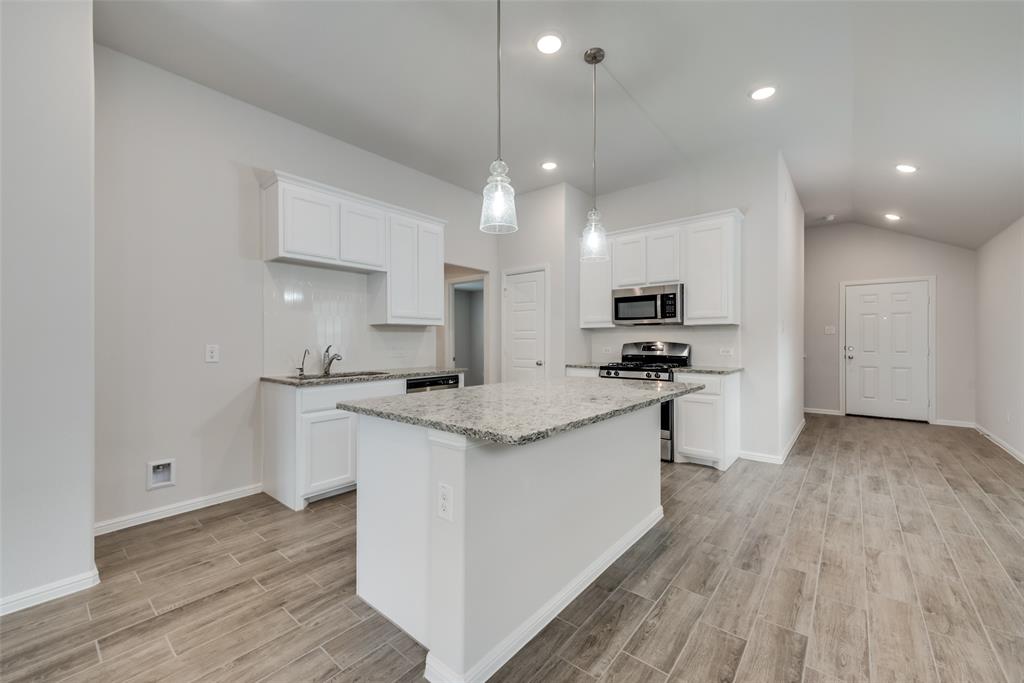 1137 Catalan Trail Mesquite, TX 75149 - Photo 9 of 22 a kitchen with granite countertop a sink and a stove top oven