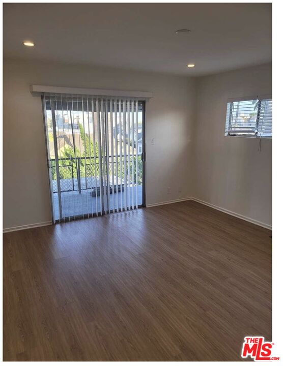 435 South Palm Drive, Unit 5 Beverly Hills, CA 90212 - Photo 5 of 13 a view of an empty room with wooden floor and a window