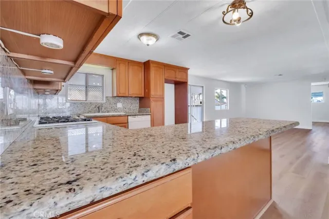 a kitchen with stainless steel appliances granite countertop a refrigerator sink and cabinets