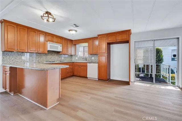 a kitchen with stainless steel appliances granite countertop a refrigerator sink and cabinets