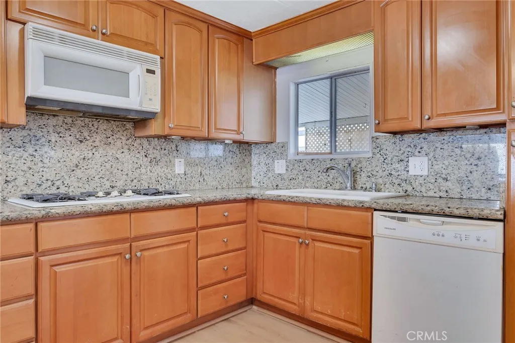 17700 Avalon, Unit 267 Carson, CA 90745 - Photo 17 of 50 a kitchen with cabinets appliances and a sink