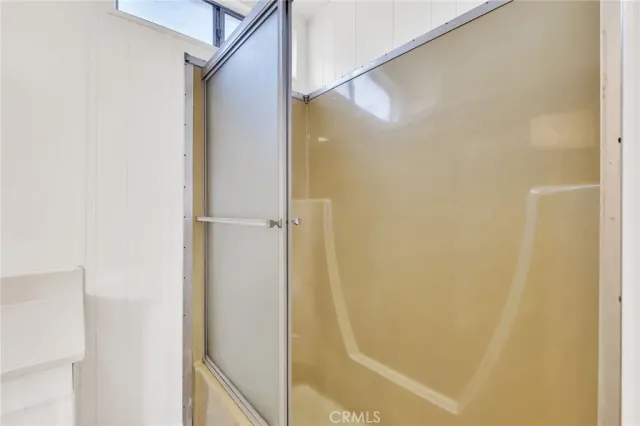 a bathroom with a glass shower door