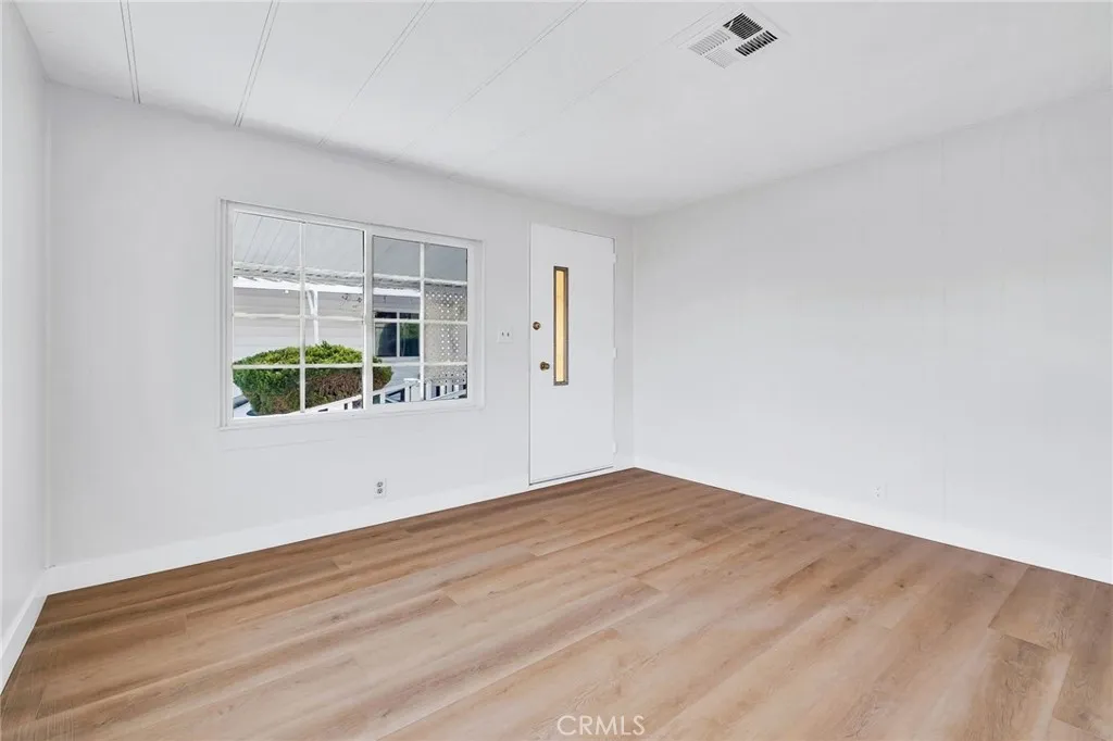 17700 Avalon, Unit 267 Carson, CA 90745 - Photo 5 of 50 an empty room with wooden floor and windows
